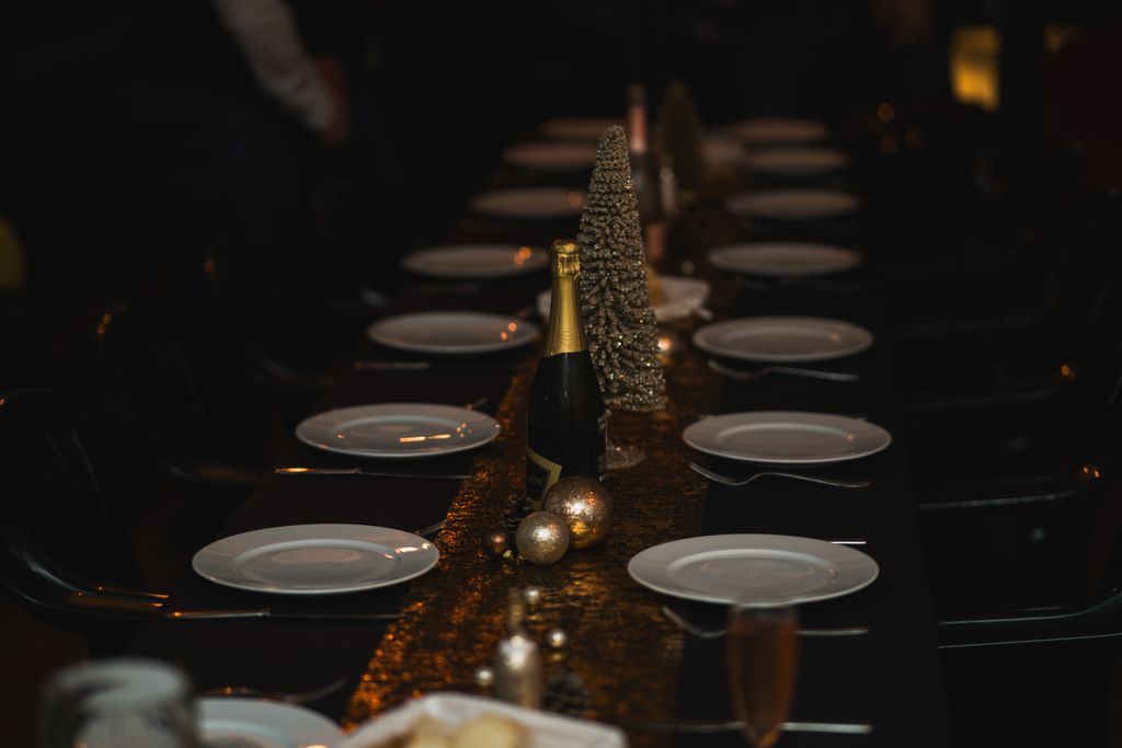 A beautifully set table for a celebration featuring champagne and festive decorations.