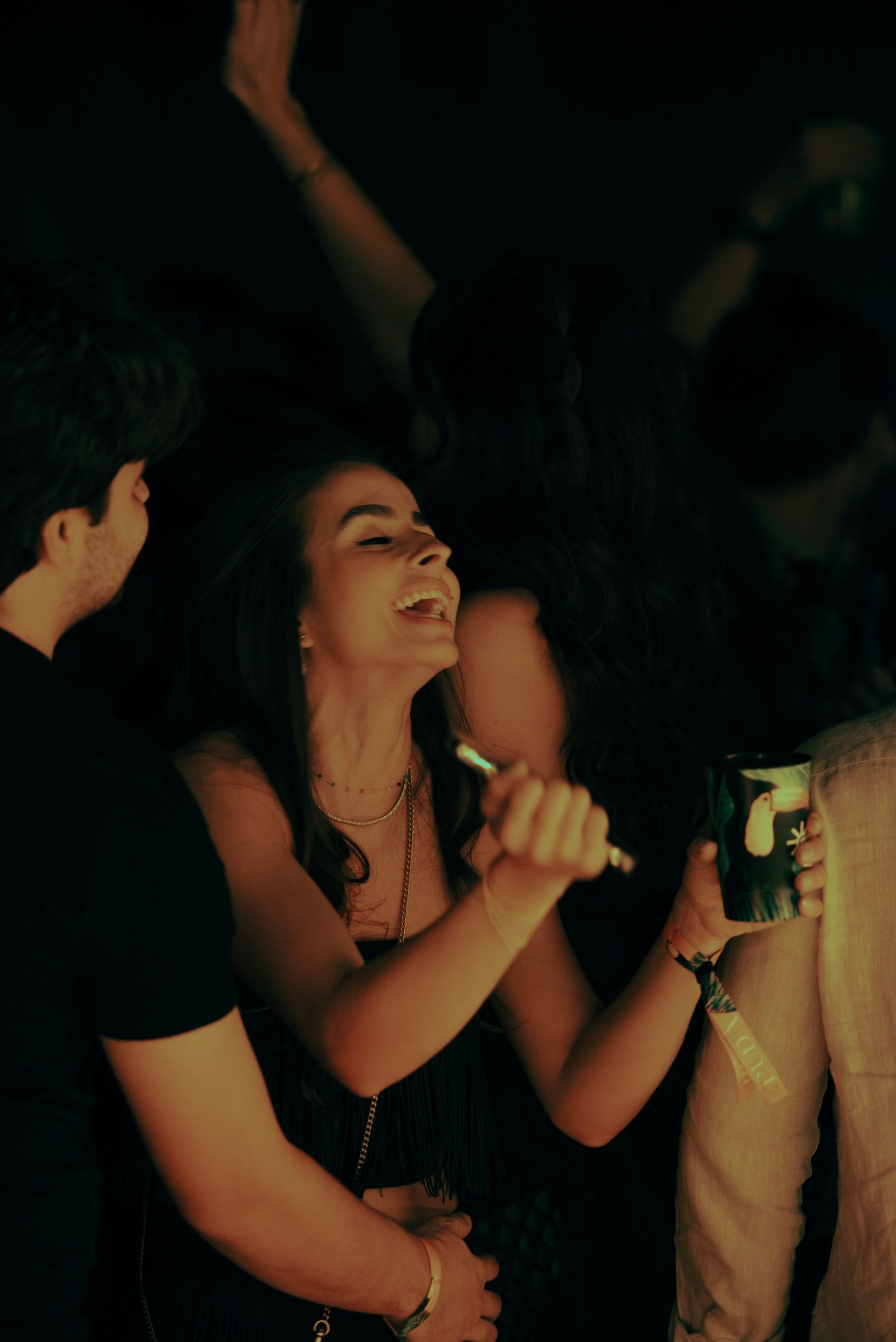 Energetic crowd enjoying a night out, dancing and having fun at a nightclub.